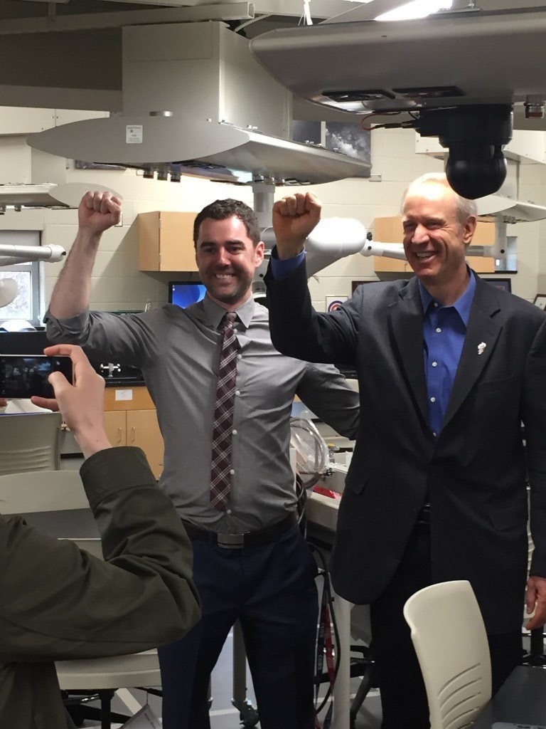 Governor Rauner and science teacher Christian Ball doing the "science fist"